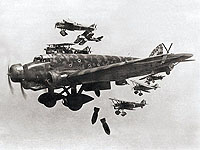 Франкистский бомбардировщик «Савойя-81» 
                сбрасывает бомбы, на заднем плане видны «Фиаты» эскорта